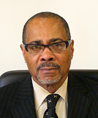 Headshot of Emory X. Brooks, President & CEO, in coat and tie with pleasant, relaxed expression.