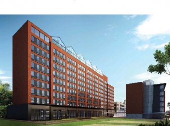 red apartment building with sunny blue sky and trees